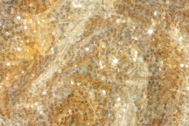 istock Gold sequin background with white silk folds on top. 2169471636
