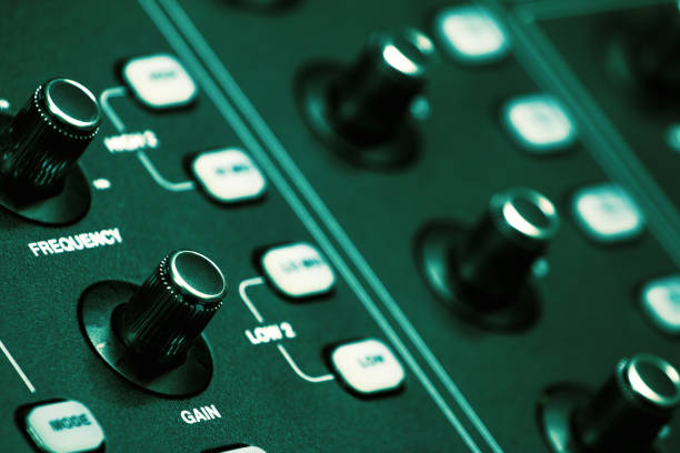 The volume control knob of a digital audio mixer in a conference room control room.
