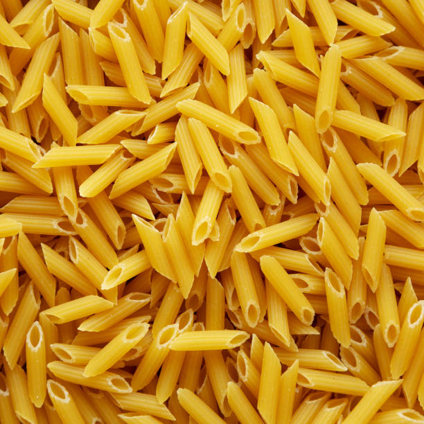 istock Homemade Raw Dry Mini Penne Pasta background 2169471809