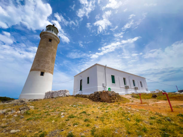 amazing lighthouse of moudari with ruins of flag signs building on kythira island, greece. - citera immagine foto e immagini stock