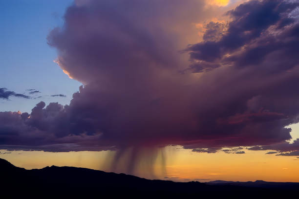 A huge mature monsoon thunderstorm towers over Prescott Arizona USA at sunset