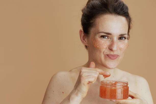 istock smiling modern female with face scrub 2169474847