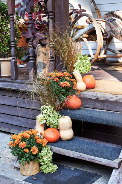 istock Autumn entryway decor, staircase decor with pumpkins and fall flowers 2169474884