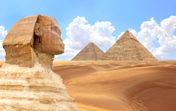 istock Famous Great Sphinx and pyramids of Chephren and Cheops, Cairo, Egypt. Great Pyramids and ancient statue of Sphinx, mythical creature with head of man and body of lion, Giza complex (Giza Necropolis) 2169475014