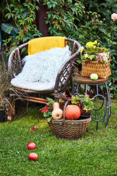 istock fall garden decor garden swing decorated with fall textiles flowers and pumpkins 2169475651