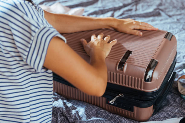istock Girl packing suitcase 2169476590