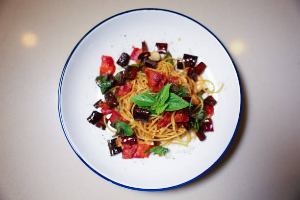 Spicy Drunken Spaghetti. Add ham, garlic, pepper, chilies,  on a white plate.