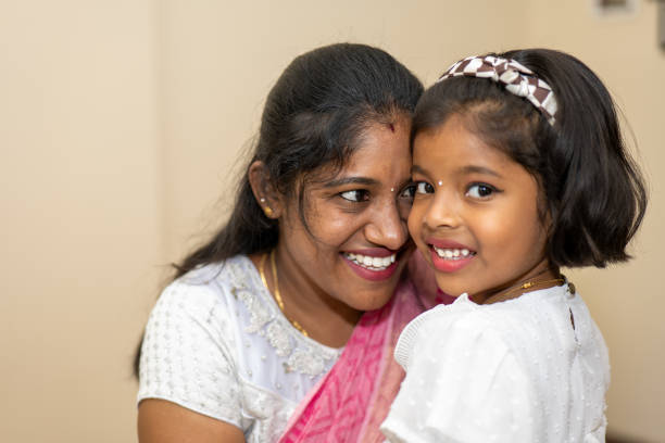 istock A woman smiles with a child beside her 2169484972