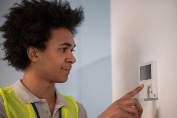 istock Dark-skinned serviceman checking the office doors locker after working day 2169485164