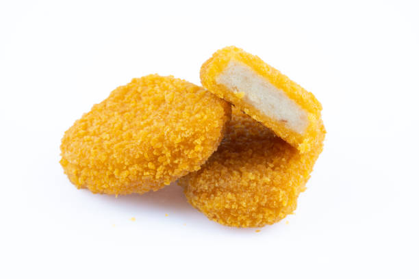 istock Delicious chicken nuggets on black background. Cooked or raw chicken nuggets 2169485291