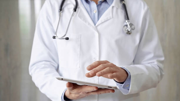 istock Doctor man with stethoscope using tablet computer in hospital. Medicine and science concepts 2169487529