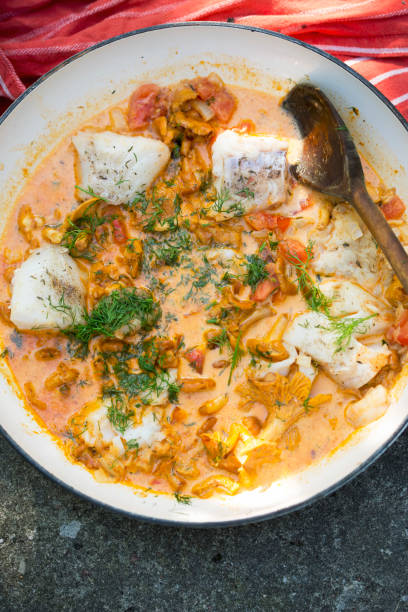 istock Cod with chanterelles and tomatoes in creamy sauce with dill 2169488794