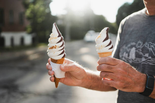 Ice-cream cone, soft serve ice cream, human hand, one person