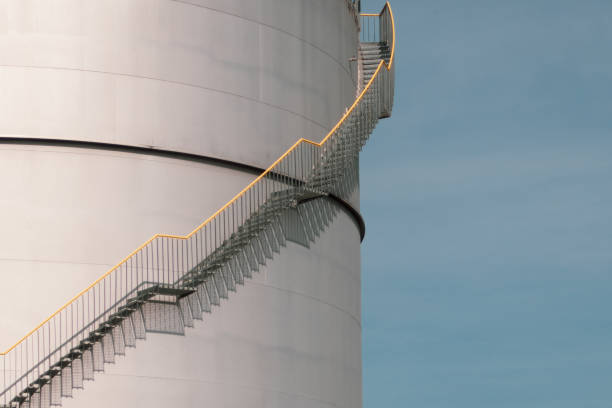 istock Spiral staircase at a large storage tank against a blue sky 2169490037