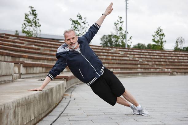 istock Mature Man in Side Plank Training Core Muscles at City Park 2169495132