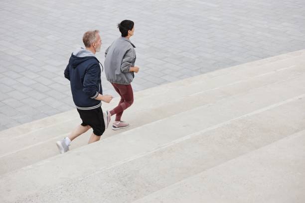 istock Elderly Couple Running along Concrete Pathways at Park 2169495190