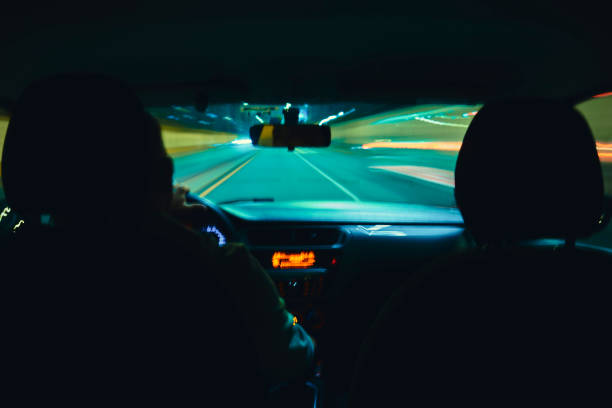 istock A blurry image of a car with two people in the front seat 2169497350
