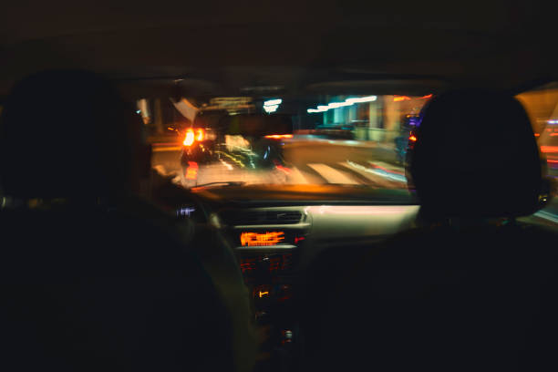 istock A blurry image of a car with two people in the front seat 2169497933
