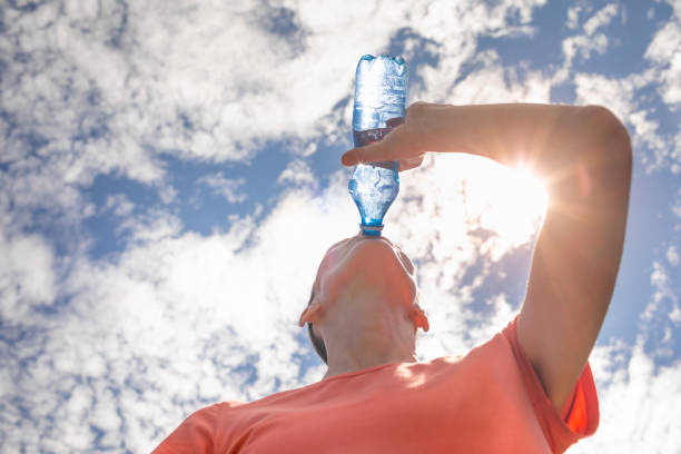 istock Woman drinking water in hot summer day. 2169498394