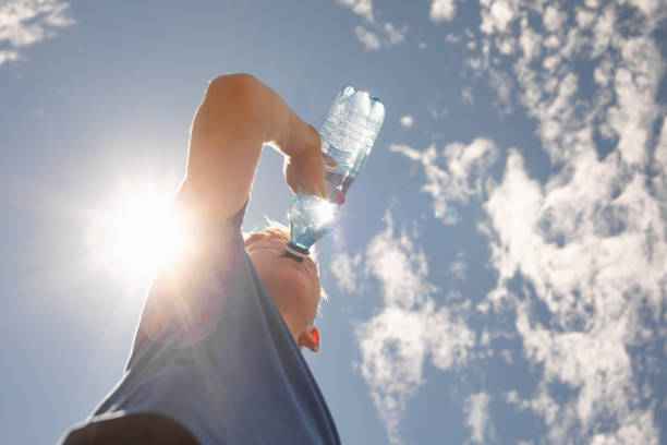 istock Little boy drinking water in hot summer day. 2169498399