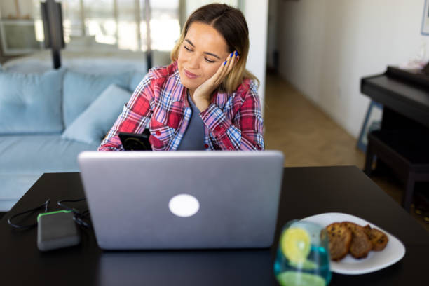 istock Woman working on her laptop at home 2169498917