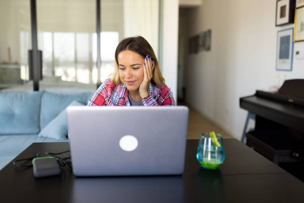 istock Woman working on her laptop at home 2169498919