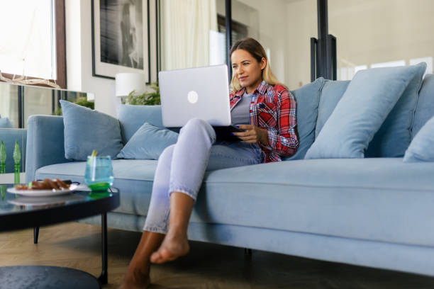 istock Woman working on her laptop at home 2169498971