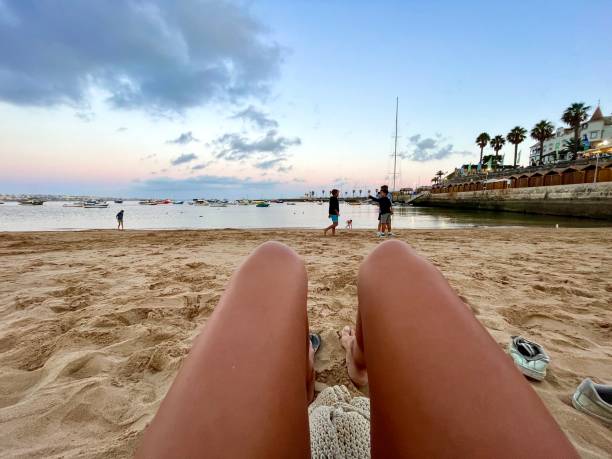 istock Legs at the beach at sunset. 2169499210