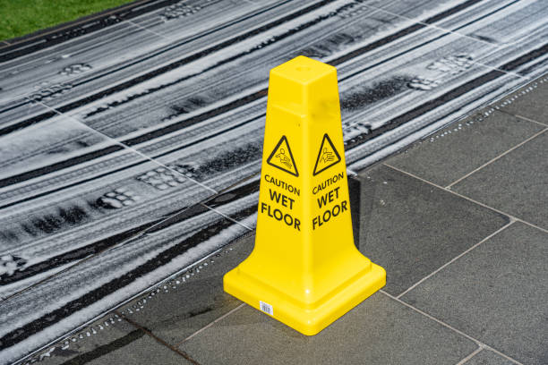 istock Wet floor danger sign or information element with detergent marks on tiled floor 2169501229