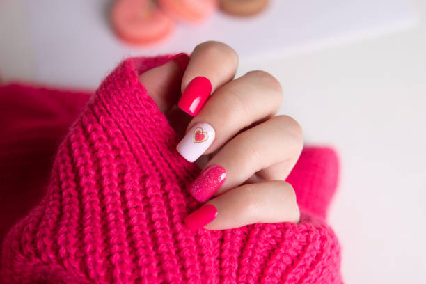 istock Female hand with pink manicure nails, heart design 2169502508