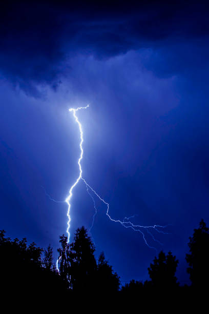 istock beautiful lightning during a thunderstorm at night in a forest that caused a fire, against a dark sky with rain 2169504584