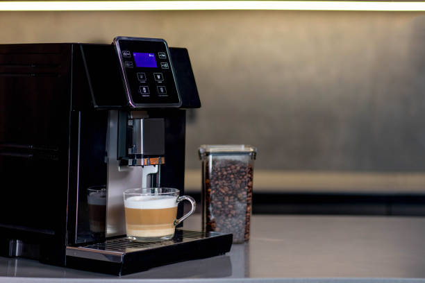istock Modern coffee machine with glass cup of latte in kitchen 2169505028