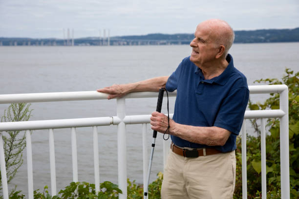 istock Blind senior man standing with blind persons walking stick 2169508522