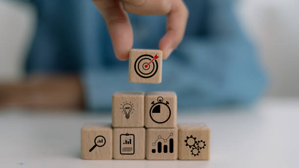 istock a business strategy, Action plan, Goal and target, hand stack woods block step on the table with icon about business strategy and Action plan. business development concept. 2169511098