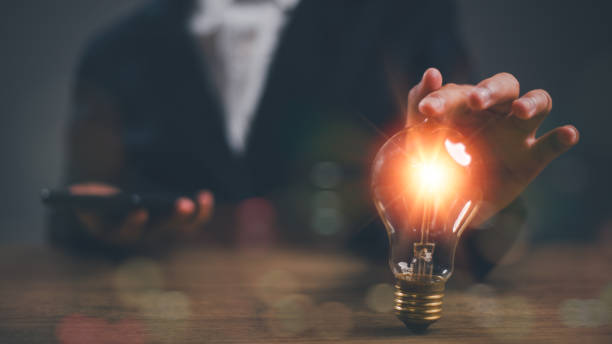 istock A businessman touches the light bulb. This is a creative new idea, innovation, brainstorming, inspiration, and solution concepts. 2169511127