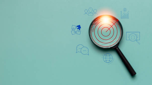 istock Target board inside magnifier glass for focus business objective on gray background and copy space. Search, goal, strategy, success. 2169511207