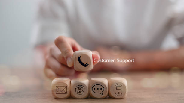 istock Website page contact us or e-mail marketing concept, Customer support hotline Contact us people connection. Label wood with the email, call phone, address, Chat message icons. 2169511220