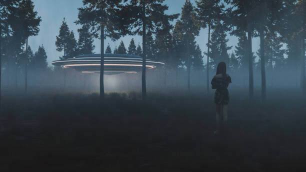 istock Young woman watching UFO in the forest 2169513513