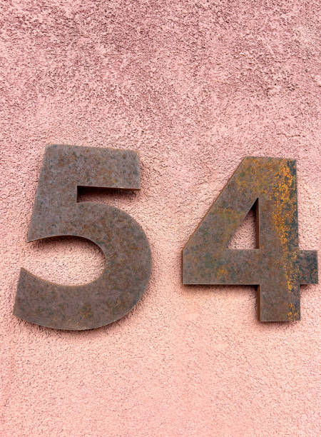 istock Rusty Number 54 Street Address on Pink Wall 2169514166