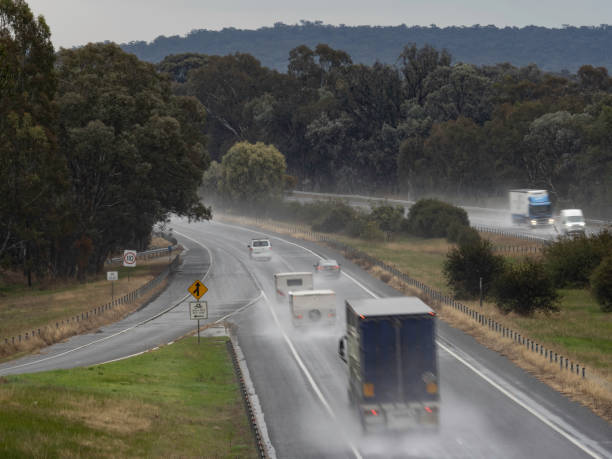 Freeway traffic in rain Freeway traffic on a wet day Hume Freeway Victoria truck rain stock pictures, royalty-free photos & images