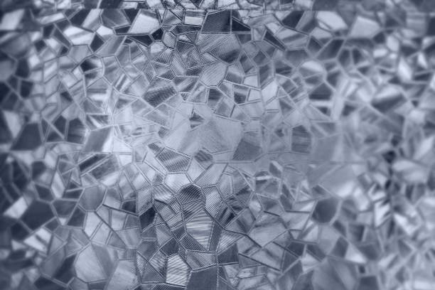 istock Embossed glass background. Corrugated glass monochrome. Refraction of light in a bumpy transparent surface under backlight. The play of white and gray highlights. Black areas. Abstract background. 2169519097