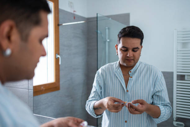 Man grooming in bathroom mirror for morning routine