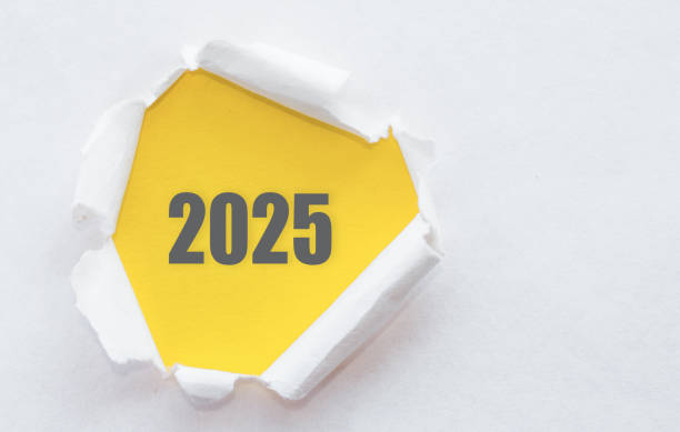 istock A vibrant yellow background displays the year 2025 creatively emerging from torn paper, symbolizing new beginnings and opportunities. 2169519567