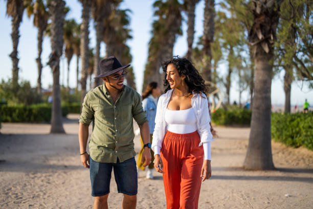 istock Joyful Diverse Couple on a Sunny Beach Walk 2169523758