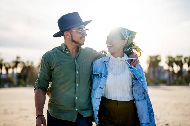 istock Hispanic Couple Enjoying a Beachside Stroll 2169523768
