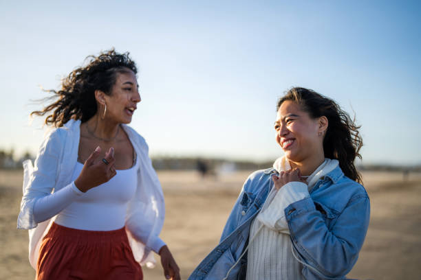istock Joyful Hispanic Friends Bonding at Coastal Setting 2169523787