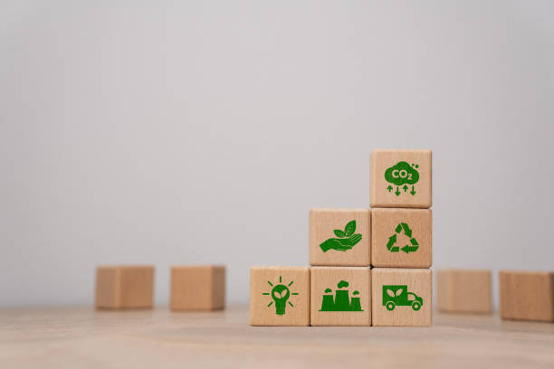 istock Green CO2 concept, Carbon, Environmental responsibility to control natural pollution. Wooden block with the word CO2 with various icons on a grey background. 2169527459