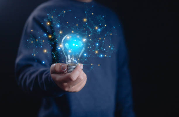 istock Idea innovate and concept. a hand holding with bulbs that shine glitter, creative thinking concept success. 2169528984