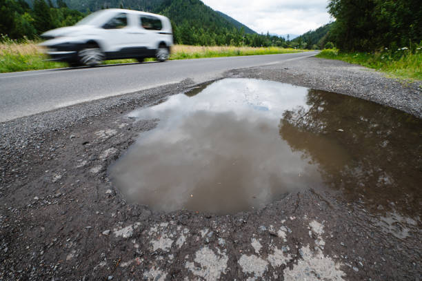 Potholes have become a huge political issue in the UK, with public anger over tyre and vehicle coverage.  This shot is in Hailsham, East Sussex, UK.