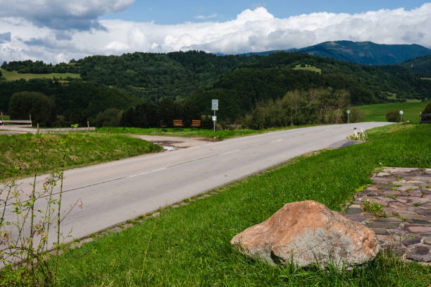 istock Car driving on rural road through scenic mountains 2169529066